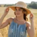 woman in a boho sleeveless dress with a wide brimmed straw hat